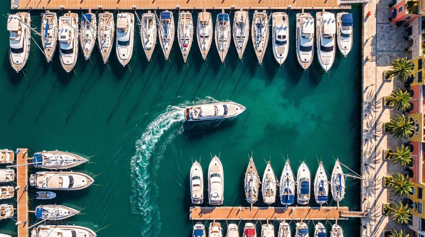 Stillwater Media vibrant aerial image of a yacht returning to its berth in a sunlit marina, illustrating CTV CRM matchback and proving CTV drives revenue